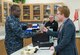 Petty Officer 1st Class Derrick Charles, Naval Training Support Center instructor, tests the grip strength of Johnathan Cristol, World Policy Institute fellow, during an occupational therapy demonstration at the Medical Education and Training Campus Nov. 30, 2016 at Joint Base San Antonio-Ft. Sam Houston, Texas. The civic leaders also toured a C-5M Super Galaxy aircraft, the Medical Training and Education Campus at Joint Base San Antonio-Ft. Sam Houston, and the Center for the Intrepid. (U.S. Air Force photo by Benjamin Faske)