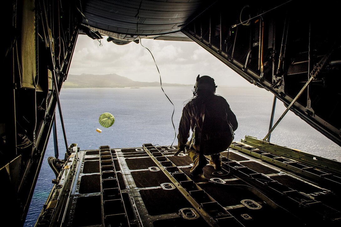 Air Force Airman 1st Class Alejandra Vargas pushes a bundle during Operation Christmas Drop at Andersen Air Force Base, Guam, Dec. 5, 2016. U.S., Australian and Japanese aircrews conducted the training event in which C-130 aircrews perform low-altitude airdrops while providing critical supplies to 56 islands. Vargas is a C-130 Hercules loadmaster assigned to the 36th Airlift Squadron. Air Force photo by Senior Airman Delano Scott