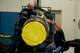 Tom Schilling (right) hands a jar of petrolatum to Gordan Lowtharp, while reassembling a C-130 jet engine, Nov. 2, 2016, at Little Rock Air Force Base, Ark. Both men are jet engine mechanics at the Air Force Reserve Command (AFRC) T-56 Centralized Repair Facility at Little Rock AFB, which produces all Legacy C-130 engine and propeller overhaul repairs for AFRC. (U.S. Air Force photo by Master Sgt. Jeff Walston/Released)