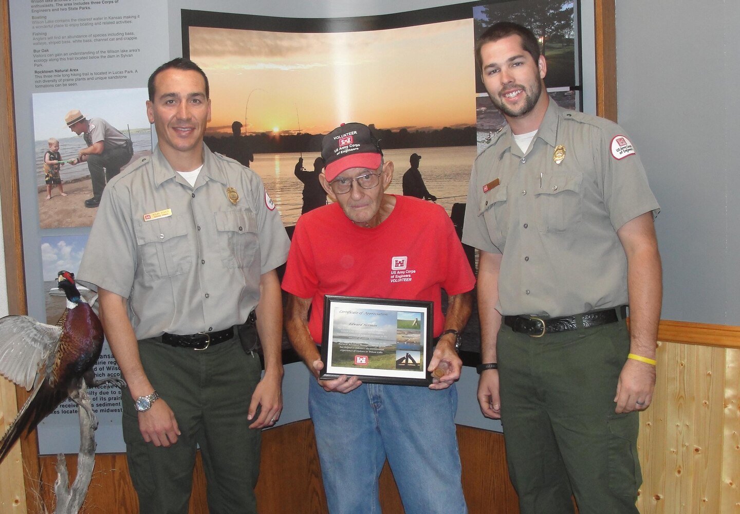 Ed Herman receives his Volunteer Excellence coin from Wilson Lake staff. Left to right, Nolan Fisher, Ed Herman, Zach Hlad. 