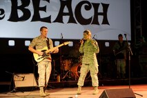 Staff Sgts. Aaron Kusterer and Courtney Clifford, U.S. Air Force Band of the Pacific-Hawaii, perform holiday and rock music during a performance at Sunset on the Beach's Air Force Night Dec. 2, 2016, at Waikiki Beach, Hawaii. The movie night featured the Air Force-themed movie "Twelve O'Clock High," and was part of a week's-long schedule of events for the 75th Commemoration of the Attack on Pearl Harbor and Oahu. (U.S. Air Force photo by Staff Sgt. Alexander Martinez)