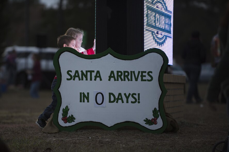 Children play near a Santa’s Arrival sign during the annual tree-lighting ceremony, Dec. 2, 2016, at Moody Air Force Base, Ga. More than $3,100 in prizes were given away during the event. (U.S. Air Force photo by Airman 1st Class Daniel Snider)