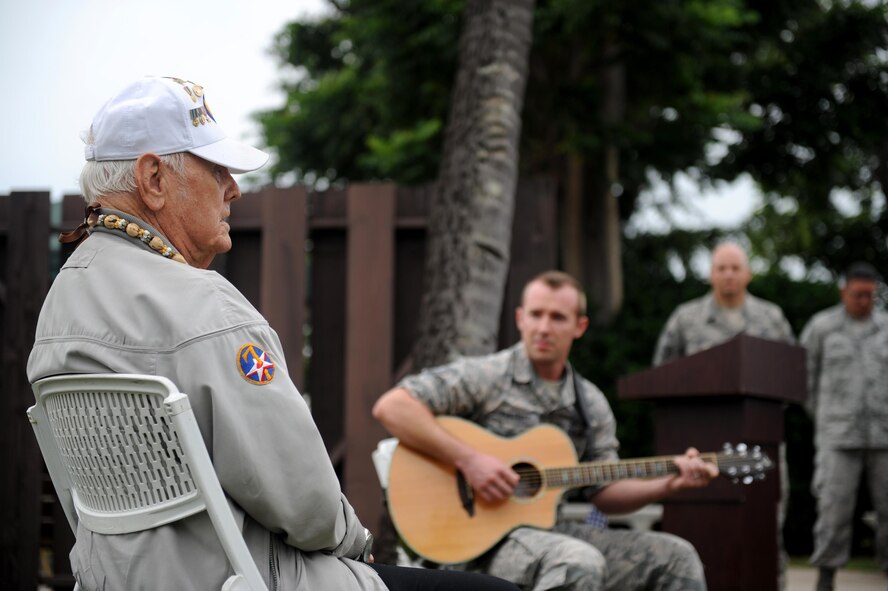 Durward Swanson (left) sings a song he wrote in memoriam of his friend, Sgt. James Strickland, during the dedication ceremony of Strickland's memorial marker Dec. 4, 2016, at Joint Base Pearl Harbor-Hickam, Hawaii. Strickland was killed near the memorial marker by Japanese gunfire during the attack on Pearl Harbor and Oahu Dec. 7, 1941. Swanson was with Strickland during his final moments, and has visited his grave at the National Memorial Cemetery of the Pacific for the past 10 years. (U.S. Air Force photo by Staff Sgt. Alexander Martinez)