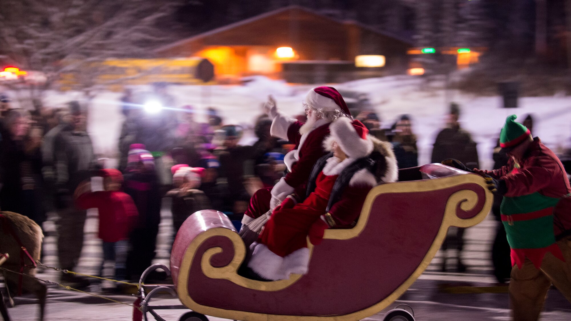 The Joint Base Elmendorf-Richardson Holiday tree lights up in front of the Joint Military Mall during the annual Holiday tree lighting, Dec. 1, 2015 at JBER, Alaska. The event featured musical selections from the Ursa Major Elementary School choir and Central Middle School choir, and a guest appearance by Mr. and Mrs. Santa Claus.
