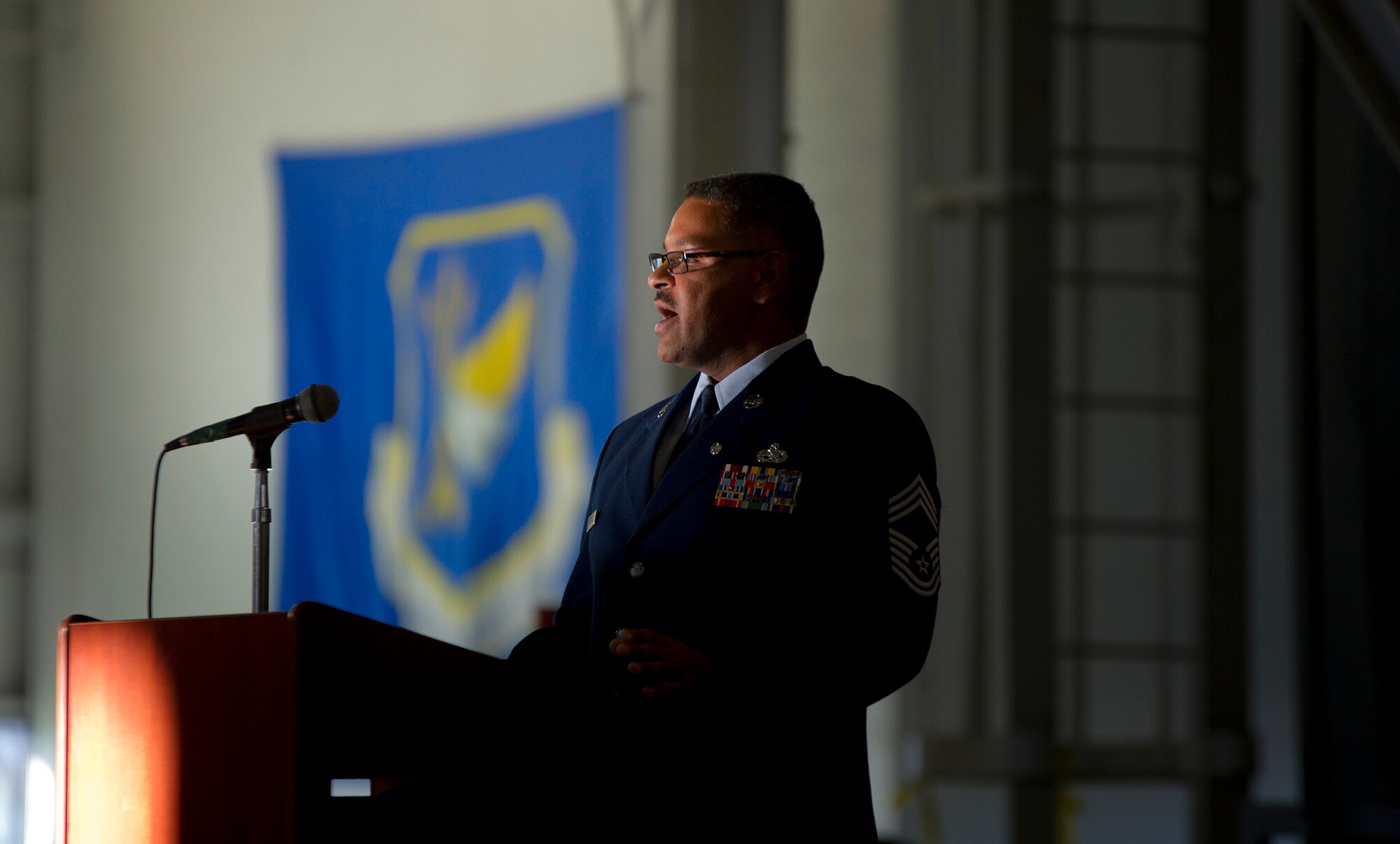 Chief Master Sgt. Dennis Christian, 714th Aircraft Maintenance Squadron maintenance superintendent, speaks to a crowd of coworkers, friends and family at his retirement ceremony Dec. 3.