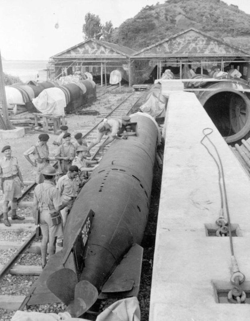 Sometime just after the end of World War II, Allied forces prepare to transport a Japanese mini-submarine on rail tracks from the warehouse to the dockside in Yokosuka, Japan.