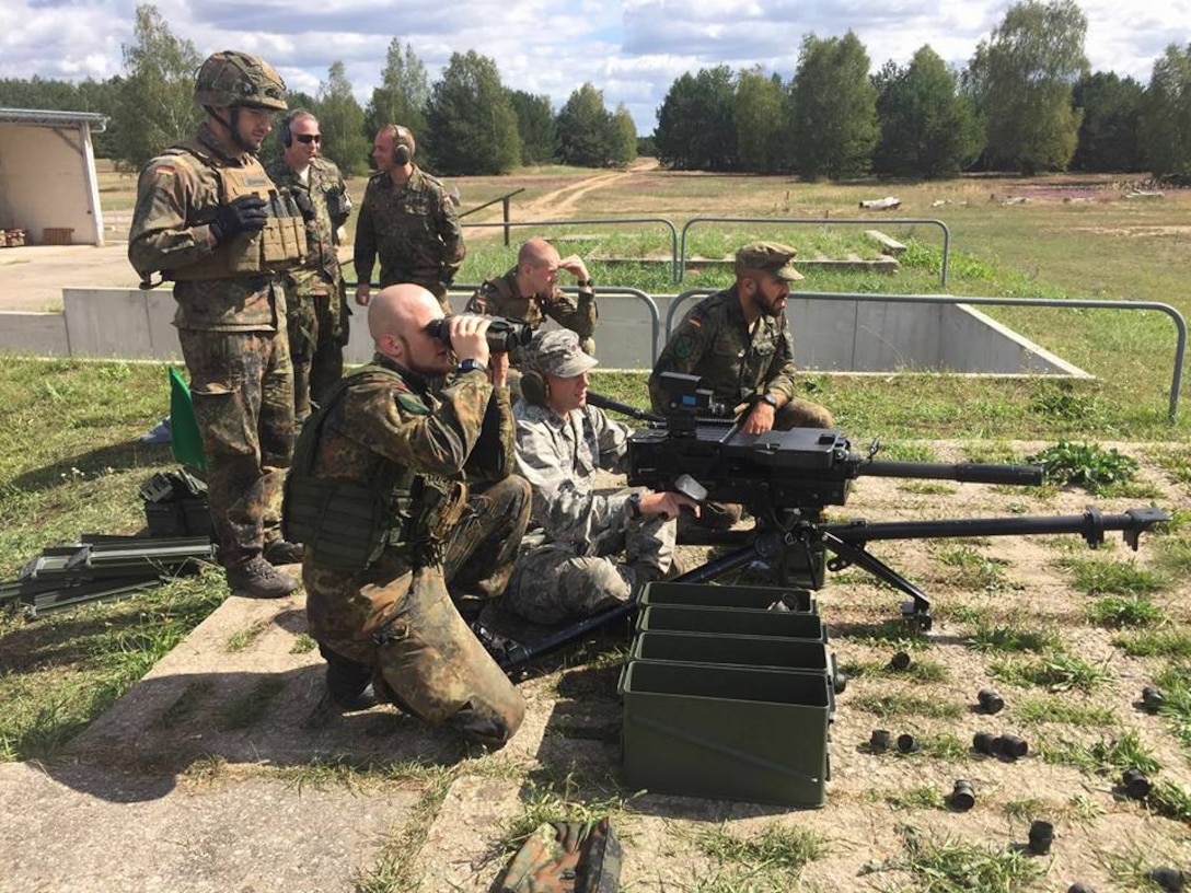 German and Army Reserve Soldiers look down range after firing 40mm HE. 