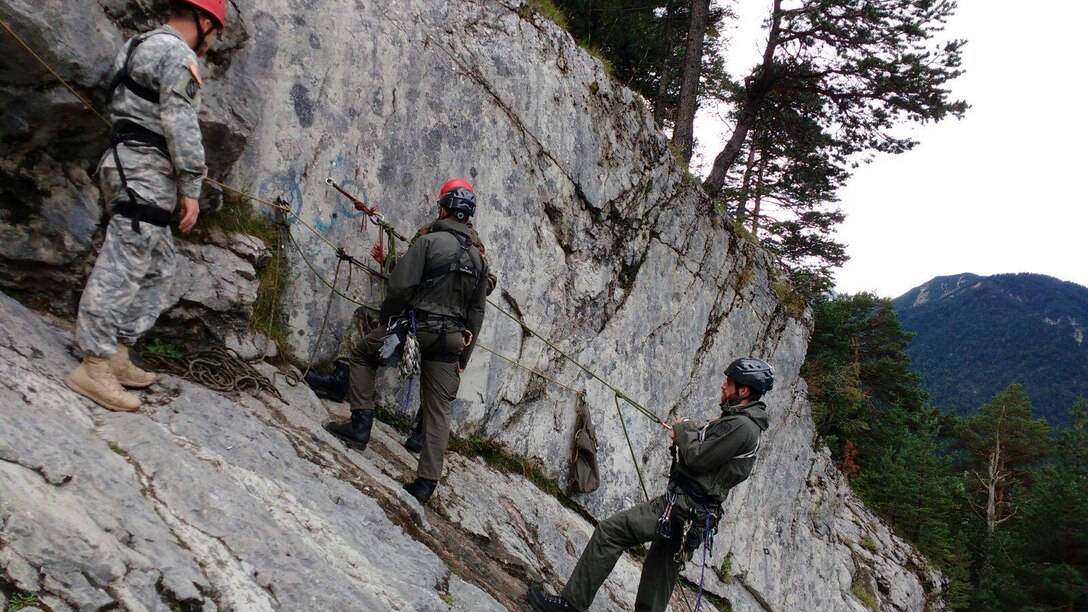 Soldiers from the Army Reserve and German Armed Forces take a rock climbing class at the Mountain Warfare School at Mittnewald.