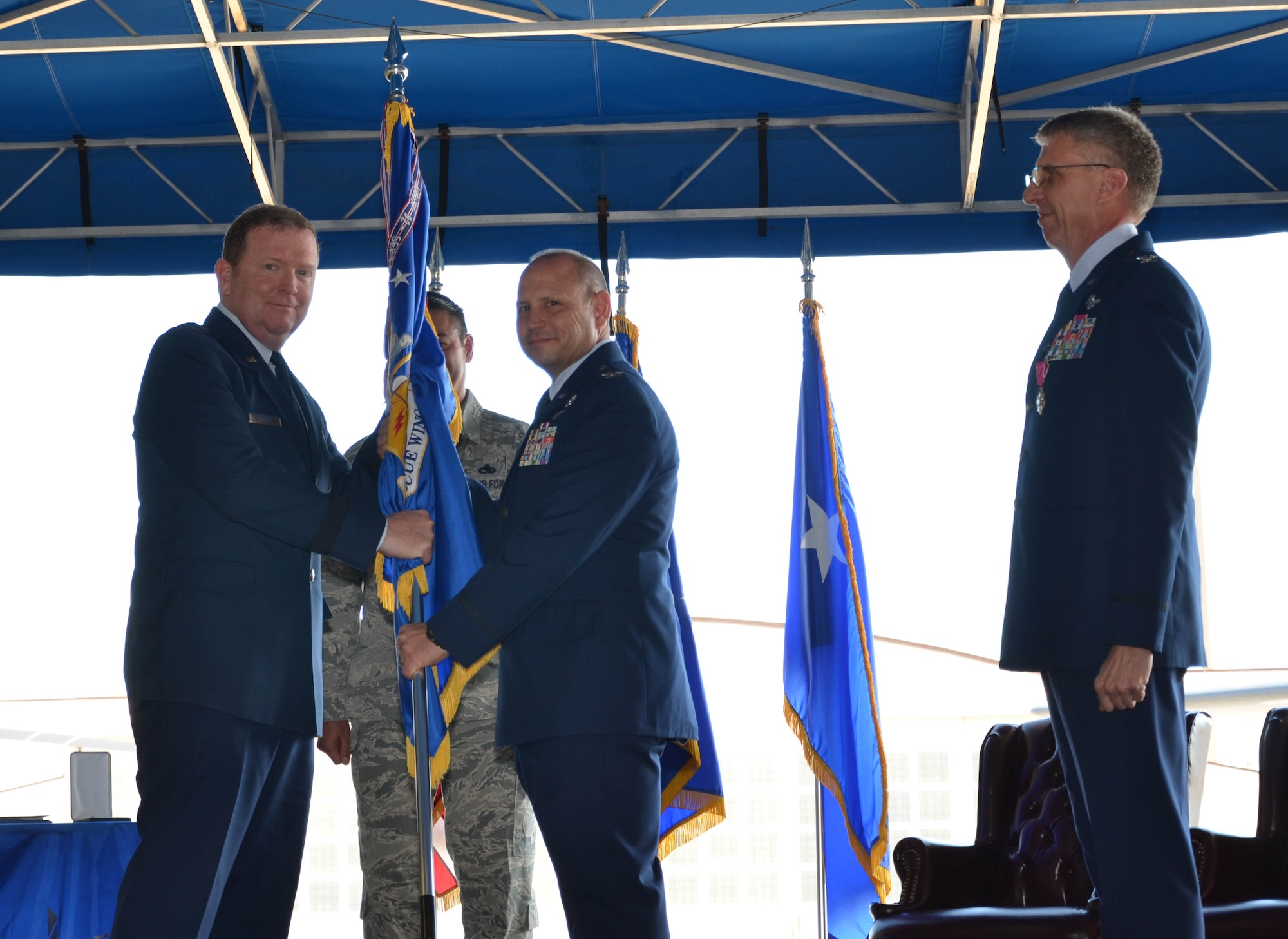 Col. Kurt Matthews (center) assumed command of the 920th Rescue Wing, Patrick Air Force Base, Florida, Dec. 3 in a change of command ceremony officiated by Maj. Gen. Richard W. Scobee, 10th Air Force commander, Naval Air Station Fort Worth Joint Reserve Base, Texas (left). Matthews replaced Col. Jeffrey L. Macrander (right) who served as the 920th RQW commander from August 2011 to December 2016. Approximately 400 civilian and military guests attended. (U.S. Air Force photo./1st Lt. Anna-Marie Wyant)