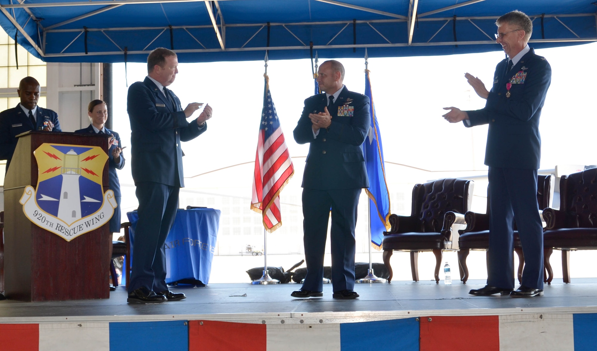 Col. Kurt Matthews (center stage) assumed command of the 920th Rescue Wing, Patrick Air Force Base, Florida, Dec. 3 in a change of command ceremony. Matthews replaced Col. Jeffrey L. Macrander (right) who served as the 920th RQW commander from August 2011 to December 2016. Maj. Gen. Richard W. Scobee (left), 10th Air Force commander, Naval Air Station Fort Worth Joint Reserve Base, Texas, officiated the ceremony that approximately 400 civilian and military guests attended. (U.S. Air Force photo./1st Lt. Anna-Marie Wyant)
