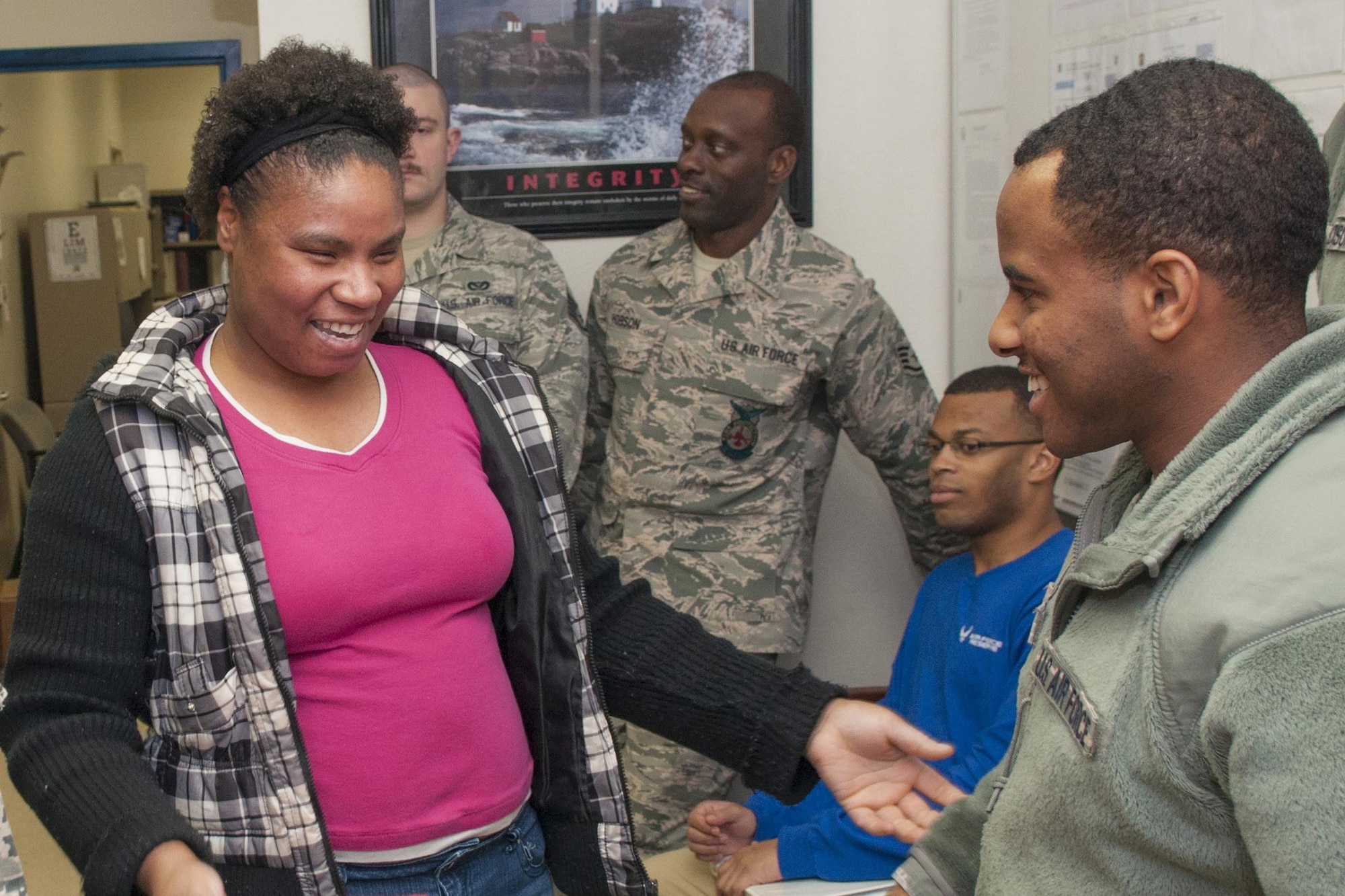 U.S. Air Force Senior Airman Ramona Gilmer, 307th Medical Squadron health services attendant, reacts to the news of receiving a gift certificate from firefighters from the 307th Civil Engineering Squadron at Barksdale Air Force Base, La., Dec. 4, 2016.   The firefighters presented her with a gift certificate and morale t-shirt as part of an annual program to recognize Airmen going above and beyond to help others.   She recently went to great lengths to help family members going through severe crisis. Seen with Gilmer is Senior Airman Jeremy Gobert, 307th CES firefighter, who was instrumental in finding out about Gilmer’s efforts and nominating her for the gift certificate. (U.S. Air Force photo by Tech. Sgt Cody Burt/released). 