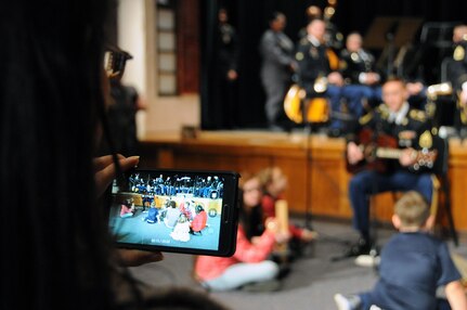 Children participate in a sing-a-long with Staff Sgt. Joseph Young.  Young is assigned to the U.S. Army Reserve’s 319th Army Band out of Fort Totten, New York.  Young and other members of the 319th played with the 78th Army Band during their holiday concert Dec. 3 in Pemberton, New Jersey.  More information about the 78th can be found on their Facebook page.