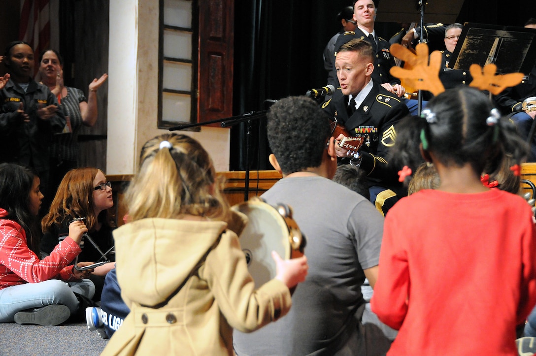 Children participate in a sing-a-long with Staff Sgt. Joseph Young.  Young is assigned to the U.S. Army Reserve’s 319th Army Band out of Fort Totten, New York.  Young and other members of the 319th played with the 78th Army Band during their holiday concert Dec. 3 in Pemberton, New Jersey.  More information about the 78th can be found on their Facebook page.