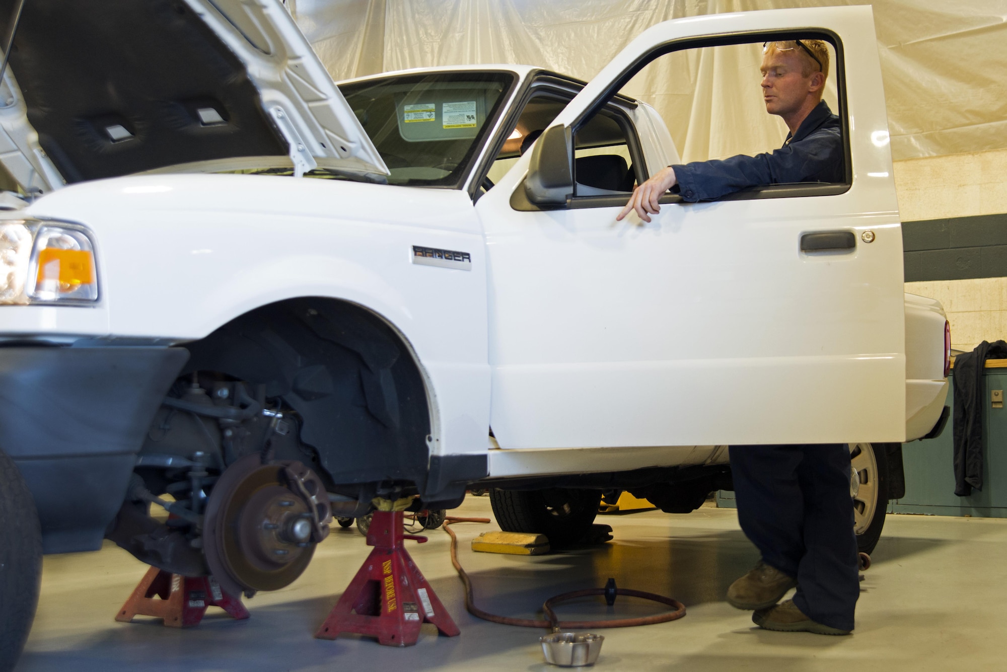U.S. Air Force Staff Sgt. Joshua Patterson, 20th Logistics Readiness Squadron vehicle maintenance journeyman, watches a truck axle as the steering wheel is turned at Shaw Air Force Base, S.C., Dec. 1, 2016. During inspection, vehicle steering is evaluated by a vehicle maintenance Airmen for wear, looseness and operation. (U.S. Air Force photo by Airman 1st Class Kathryn R.C. Reaves)