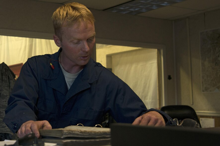 U.S. Air Force Staff Sgt. Joshua Patterson, 20th Logistics Readiness Squadron vehicle maintenance journeyman, looks through a systems code book to title vehicle repairs at Shaw Air Force Base, S.C., Dec. 1, 2016. If a vehicle maintenance Airmen determines a vehicle needs to be fixed or have parts replaced, they title the maintenance task with a code to eliminate the need for detailed written instructions. (U.S. Air Force photo by Airman 1st Class Kathryn R.C. Reaves)