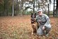 Senior Airman Kasandra Groff, a 628th Medical Operations Squadron Mental Health Clinic mental health technician, kneels next to Sergeant Stoeger, an animal assisted activity dog and Groff's pet, here, Dec. 1, 2016. As an assisted activity animal dog, Stoeger is able to sit in on appointments when requested by patients and attend mental health immersions around base.