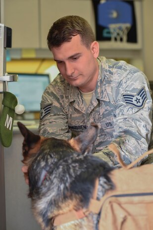Staff Sgt. Max Rasmussen, 628th Medical Operations Squadron Mental Health Clinic Mental Health Clinic Alcohol Drug and Abuse Prevention Treatment program NCO in charge, plays with Sergeant Stoeger, an animal assisted activity dog, here, Dec. 1, 2016. As an assisted activity animal dog, Stoeger is able to sit in on appointments when requested by patients and attend mental health immersions around base.