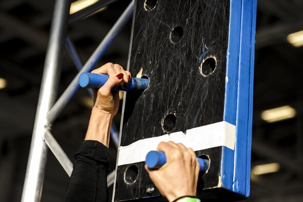 An Alpha Warrior competitor climbs a peg board while completing an obstacle course during the Alpha Warrior competition at Hurlburt Field, Fla., Dec. 3, 2016. The course was composed of several obstacles including a salmon ladder, three ring ropes and a rope climb. Contestants had to finish the course in under three minutes. (U.S. Air Force photo by Airman Dennis Spain)