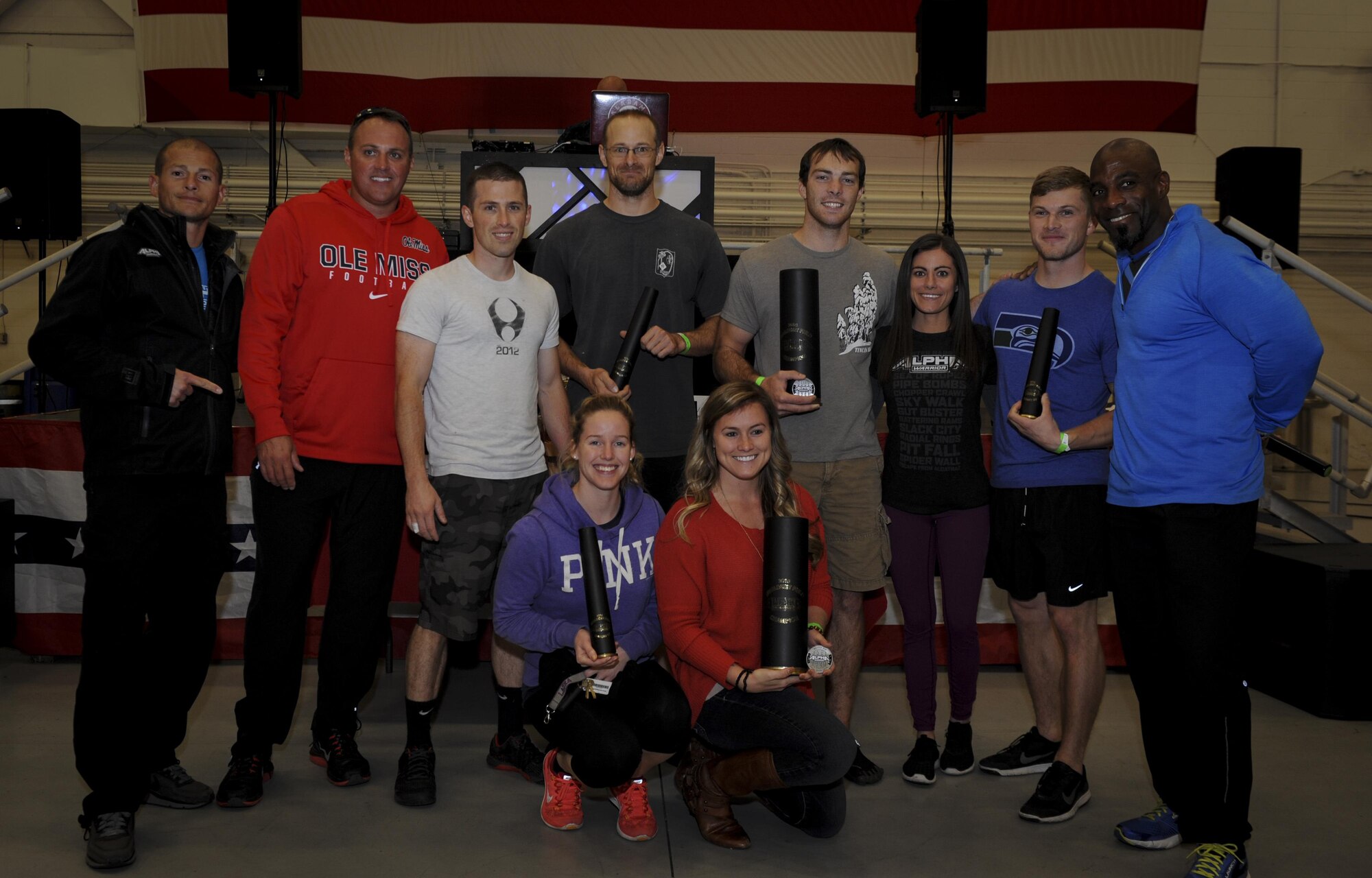 Winners of the Alpha Warrior competition hold their prizes in the Freedom Hangar at Hurlburt Field, Fla., Dec. 3, 2016. Alpha Warrior representatives presented awards to the first, second and third place winners of the male and female divisions. (U.S. Air Force photo by Airman Dennis Spain)