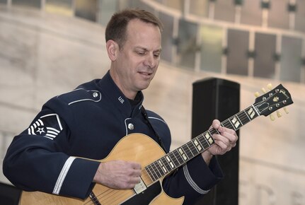 Master Sgt. Geoffrey Reecer, U.S. Air Force Band’s Airmen of Note guitarist, performs at the National Museum of American History in Washington, D.C., Dec. 3, 2016. The group played holiday favorites throughout the afternoon for museum visitors to spread cheer during the season. (U.S. Air Force photo by Senior Airman Jordyn Fetter)