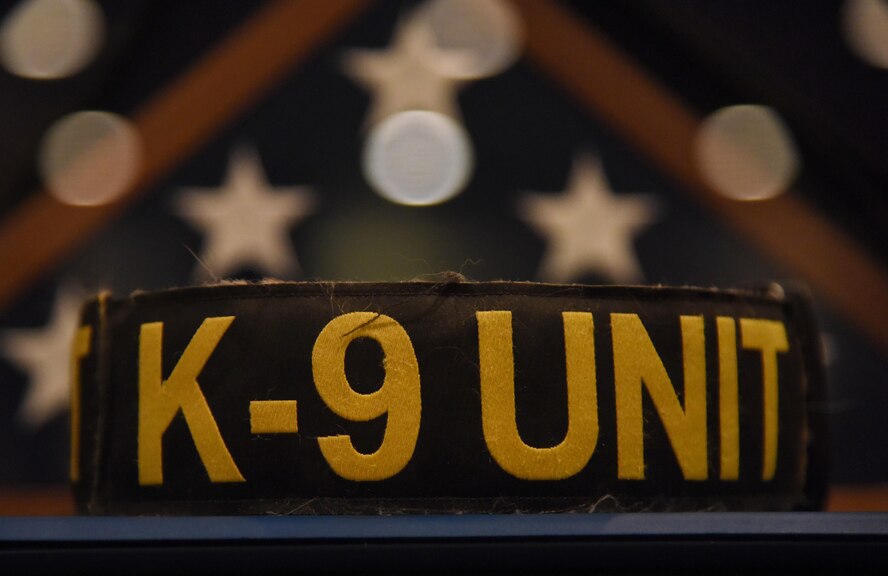 A K-9 Unit dog collar sirs on display during a retirement ceremony for Densy and Ares, 81st Security Forces Squadron military working dogs, at the Keesler Medical Center Don Wylie Auditorium Dec. 2, 2016, on Keesler Air Force Base, Miss. Densy and Ares served more than 17 years combined in the Air Force. (U.S. Air Force photo by Kemberly Groue)