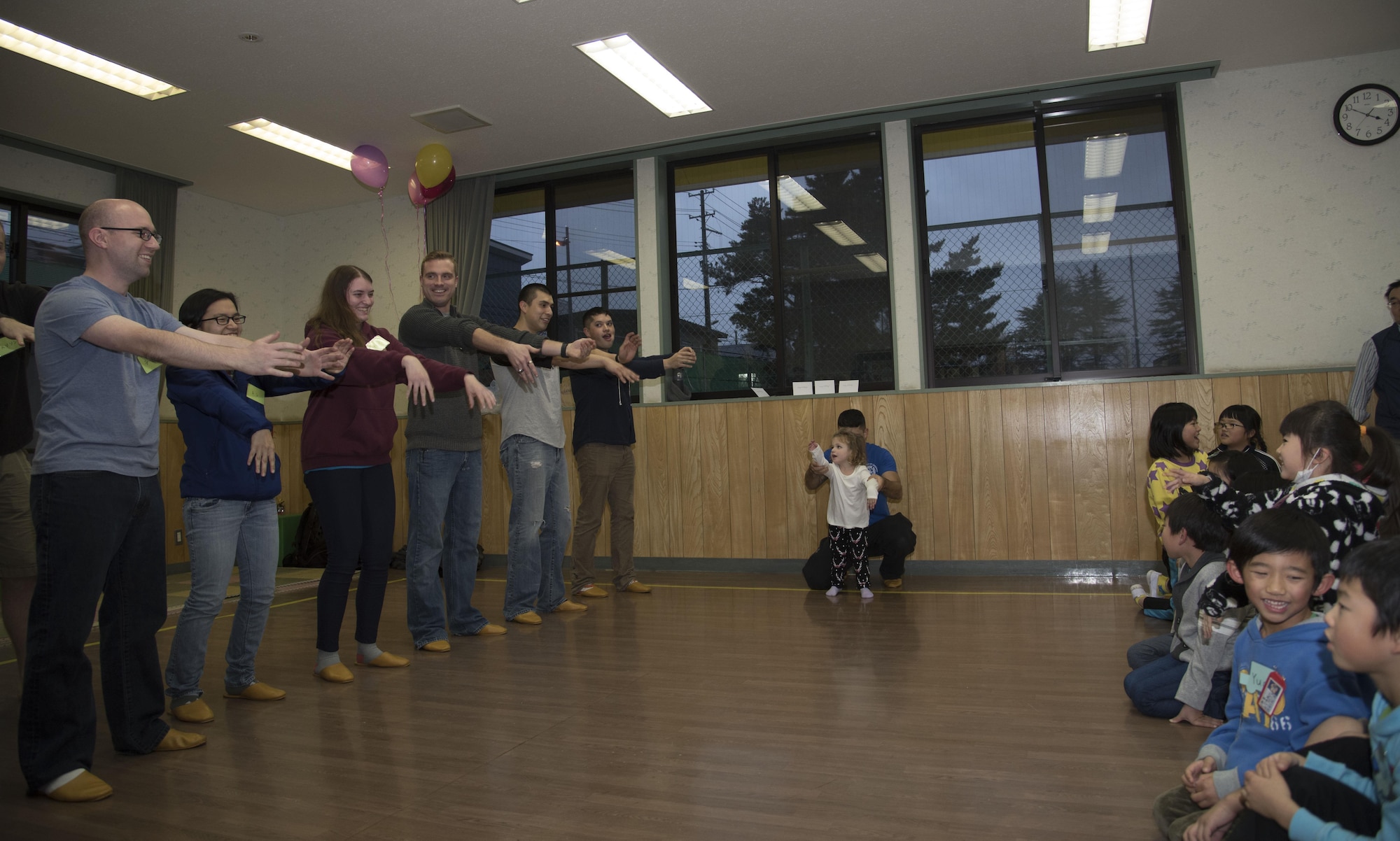 Airmen with the 35th Fighter Wing teach grade schoolers the "Hokey-Pokey" at Okamisawa Grade School, Misawa City, Japan, Nov. 22, 2016. The program, Jido-kan, is a mentorship program headed by the 35th Civil Engineer Squadron used to give back to Japan and foster good relations within the local community. (U.S. Air Force photo by Airman 1st Class Sadie Colbert)