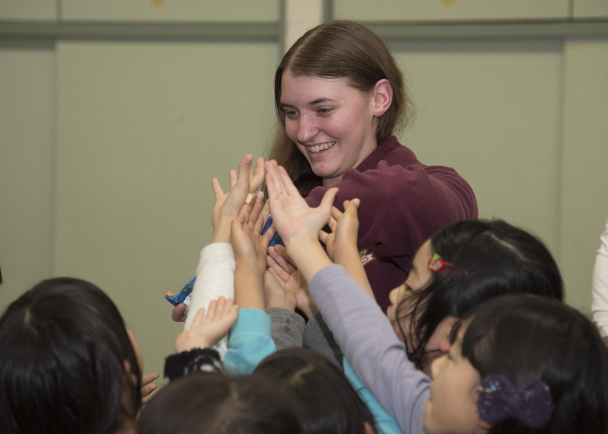 U.S. Air Force Airman 1st Class Allison Sokora, a 35th Communications Squadron cyber transport technician, hands out candy to children at Okamisawa Grade School, Misawa City, Japan, Nov. 22, 2016. According to 2nd Lt. Jacob McGill, the 35th Civil Engineer Squadron program development chief, said Jido-kan provides an outlet to expand and help others in the local community. (U.S. Air Force photo by Airman 1st Class Sadie Colbert)