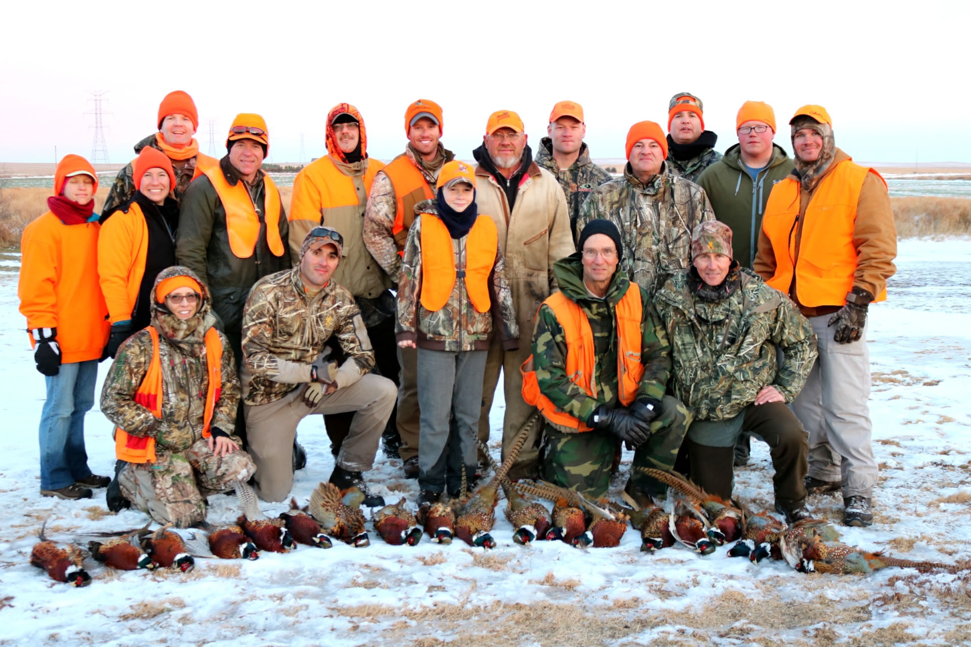 Terry Ness (back row center) and retired Lt. Col. Gerald Walzel (fourth front row) provided Airmen and their families an opportunity to experience pheasant hunting on their land near Onida, S.D., Nov. 19, 2016. Ness and Walzel have provided two weekends of pheasant hunting each season for Ellsworth Airmen since 2012. (Courtesy photo provided by 1st Lt. Jamie Seals)