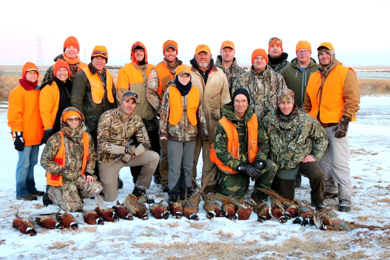 Terry Ness (back row center) and retired Lt. Col. Gerald Walzel (fourth front row) provided Airmen and their families an opportunity to experience pheasant hunting on their land near Onida, S.D., Nov. 19, 2016. Ness and Walzel have provided two weekends of pheasant hunting each season for Ellsworth Airmen since 2012. (Courtesy photo provided by 1st Lt. Jamie Seals)