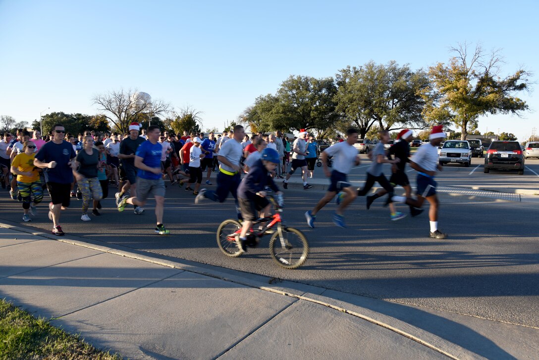 Jingle All the Way 5k participants begin running at the Taylor Chapel on Goodfellow Air Force Base, Texas, Dec. 1, 2016. The run brought our 385 people and was the kick-off to the annual tree lighting ceremony. (U.S. Air Force photo by Staff Sgt. Joshua Edwards/Released)