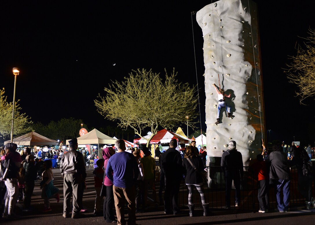 Rock climbing was available for all guests during Holiday Magic Dec. 3, 2016 at Luke Air Force Base, Ariz. The event featured bouncy houses and vouchers for free Christmas trees to Luke community members. (U.S. Air Force photo by Airman First Class Alexander Cook)