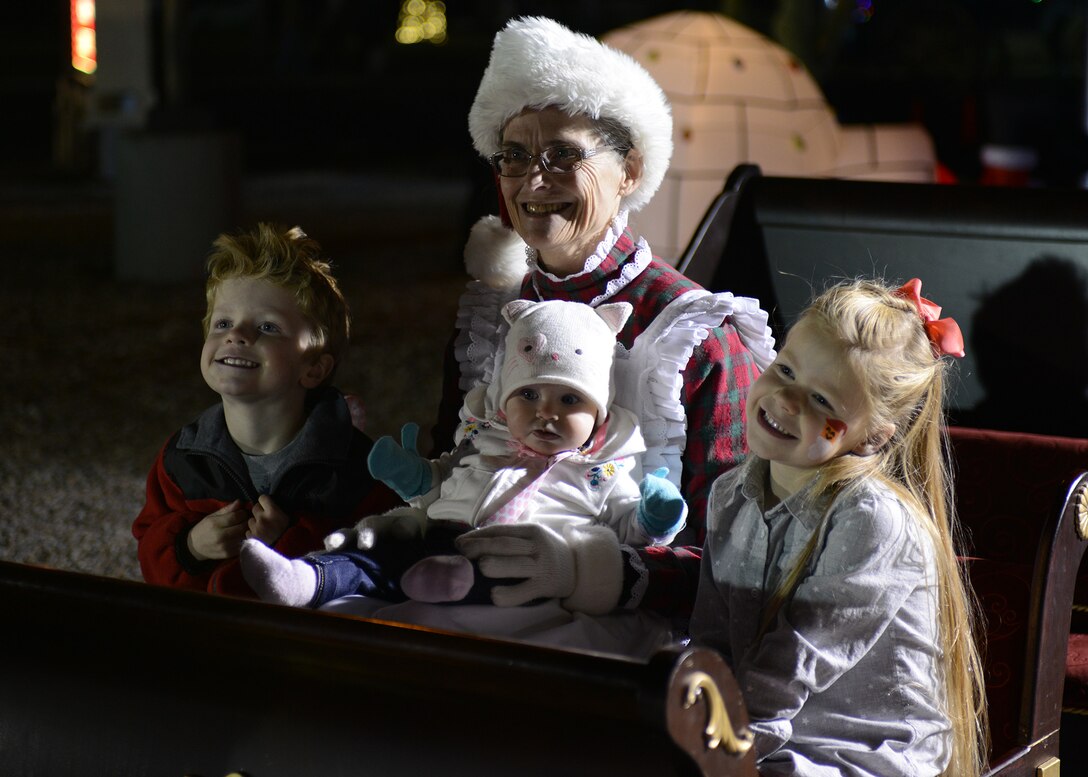Mrs. Claus takes a photo with children during Holiday Magic Dec. 3, 2016 at Luke Air Force Base, Ariz.  The event featured rock climbing, bouncy houses, and vouchers for free Christmas trees to Luke community members. (U.S. Air Force photo by Airman First Class Alexander Cook)