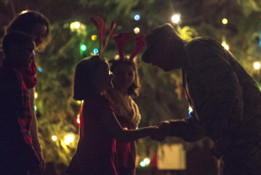 U.S. Air Force Col. Kenneth E. Moss, 374th Airlift Wing commander, thanks the family of a deployed service member for their assistance at a tree lighting ceremony at the main chapel at Yokota Air Base, Japan, Dec. 1, 2016. The tree lighting marks the official start of the holiday season at Yokota. (U.S. Air Force Photo by Airman 1st Class Juan E. Torres/Released)