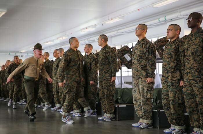 Staff Sgt. Steven M. Fowler, drill instructor, India Company, 3rd Recruit Training Battalion, instructs a recruit to move faster during pick up at Marine Corps Recruit Depot San Diego, Dec. 2. During their time at recruit training, the recruits will be pushed to their limits by their drill instructors as they attempt to become basically-trained Marines. Annually, more than 17,000 males recruited from the Western Recruiting Region are trained at MCRD San Diego. India Company is scheduled to graduate Feb. 24.