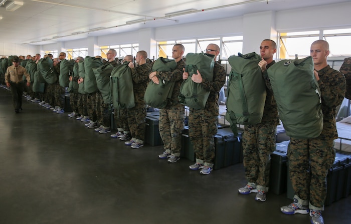 Recruits of India Company, 3rd Recruit Training Battalion, hold up their sea bags during pick up at Marine Corps Recruit Depot San Diego, Dec. 2. Recruits use their sea bags as additional storage for their gear while in training. Annually, more than 17,000 males recruited from the Western Recruiting Region are trained at MCRD San Diego. India Company is scheduled to graduate Feb. 24.