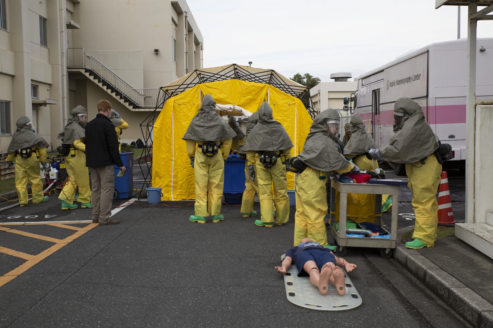 The hazardous material, or hazmat, team with the Robert M. Casey Medical and Dental Clinic respond to a simulated chemical attack during decontamination training at Marine Air Station Iwakuni, Japan, Dec. 1, 2016. The clinic holds decontamination training biannually to prepare the base for real-world chemical contaminations. (U.S. Marine photo by Lance Cpl. Gabriela Garcia-Herrera)