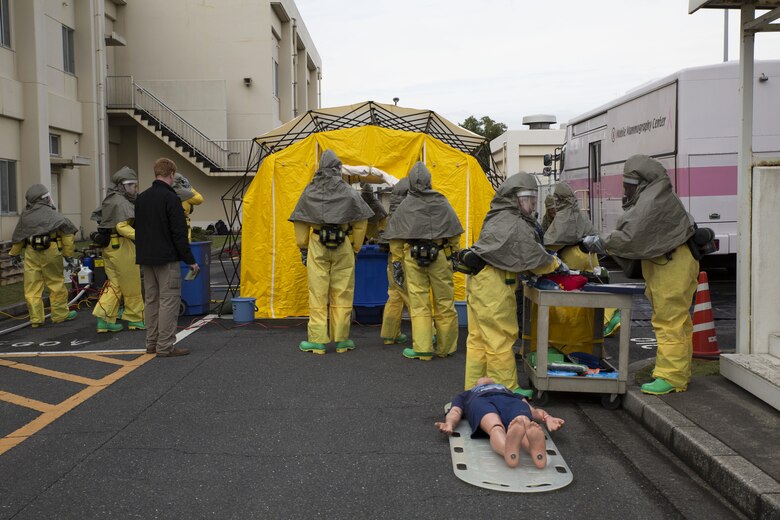 The hazardous material, or hazmat, team with the Robert M. Casey Medical and Dental Clinic respond to a simulated chemical attack during decontamination training at Marine Air Station Iwakuni, Japan, Dec. 1, 2016. The clinic holds decontamination training biannually to prepare the base for real-world chemical contaminations. (U.S. Marine photo by Lance Cpl. Gabriela Garcia-Herrera)