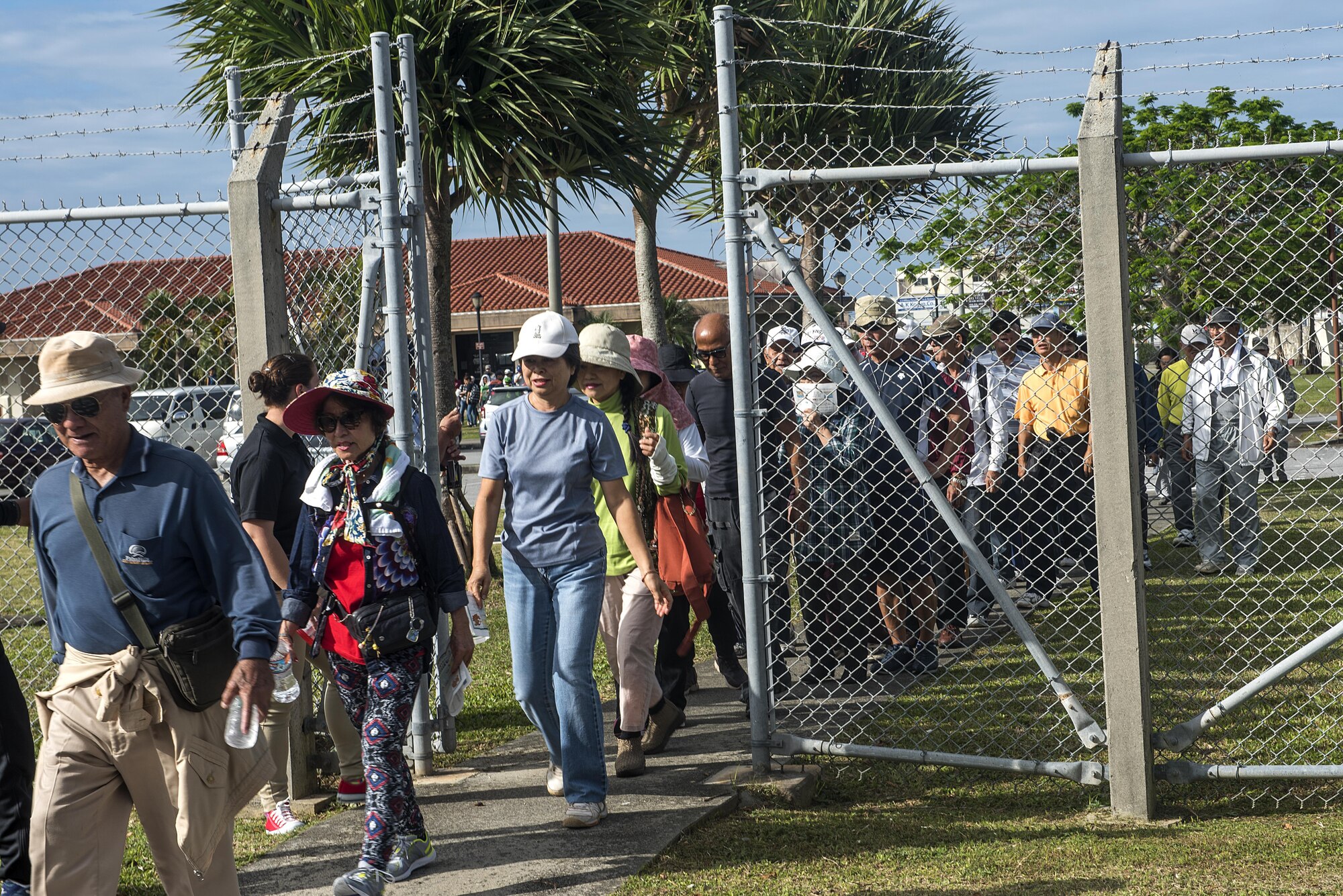 Residents of Chatan Town make their way to the entrance of Kadena Air Base, Japan, as part of a bilateral tsunami evacuation exercise Dec. 4, 2016. Security Forces Personnel provided gate entry to all participants and provided escorts as local residents made their way to a designated recovery zone. (U.S. Air Force photo by Airman 1st Class Corey Pettis/Released)