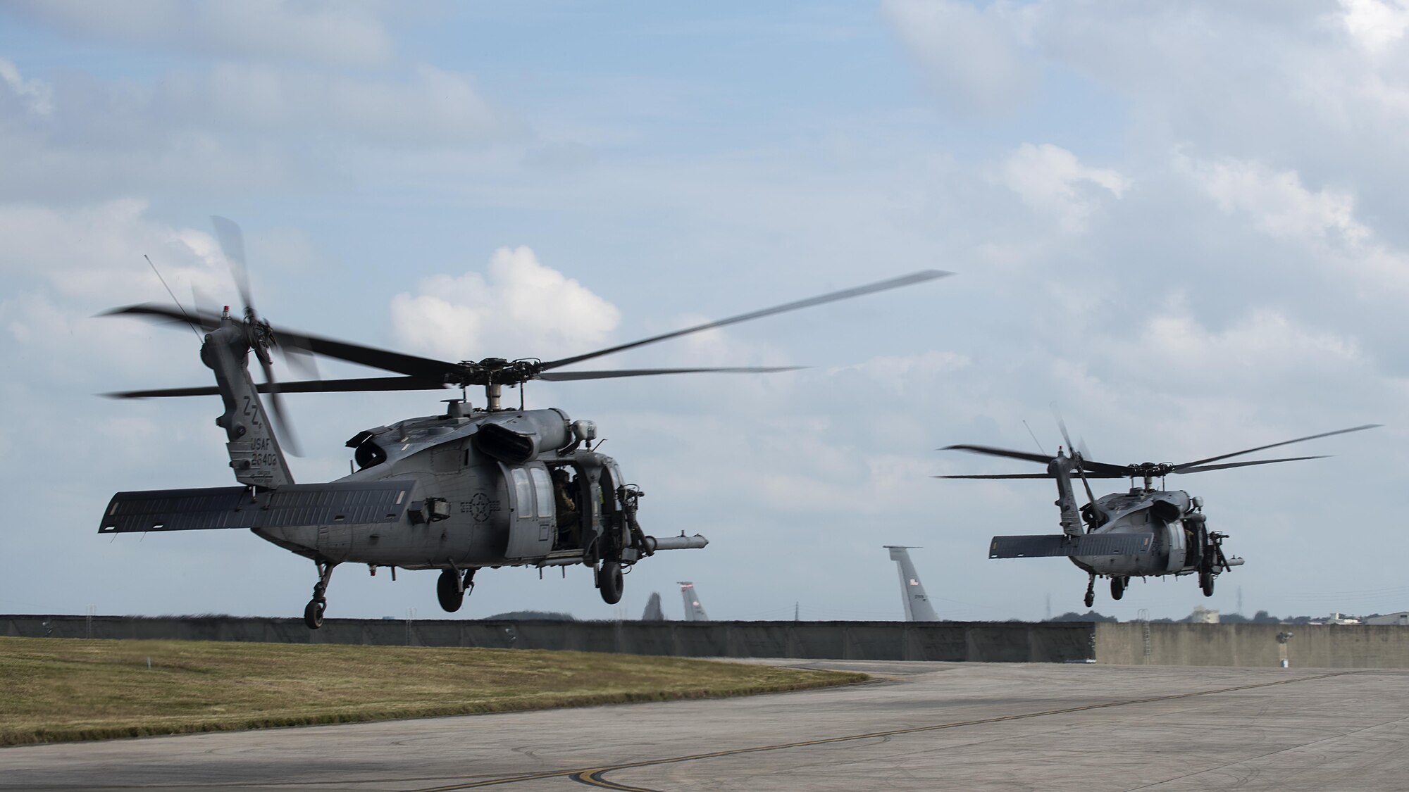U.S. Air Force HH-60G Pave Hawks from the 33rd Rescue Squadron take off Nov. 30, 2016, at Kadena Air Base, Japan. HH-60G rescue equipment includes a hoist capable of lifting a 600-pound load from a hover height of 200 feet, and a personnel locating system that is compatible with the PRC-112 survival radio and provides range and bearing information to a survivor's location. (U.S. Air Force photo by Airman 1st Class Corey Pettis/Released)