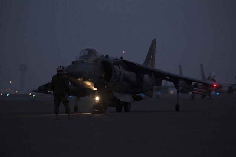 U.S. Marines with Marine Attack Squadron (VMA) 542 guide a U.S. Marine Corps AV-8B Harrier on the flight line after its arrival to Chitose Air Base, Japan, Dec. 5, 2016. Following the arrival of the squadron’s Harriers, a press conference was held to acknowledge questions pertaining to the aircraft and the Aviation Training Relocation Program. (U.S. Marine Corps photo by Lance Cpl. Joseph Abrego)