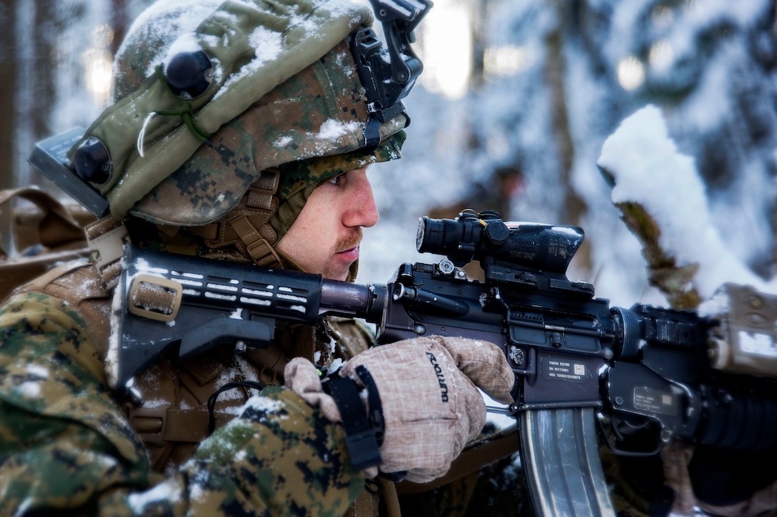 A Marine searches and assesses his target during Exercise Iron Sword 16 in the Rukla Training Area, Lithuania, Nov. 29, 2016. The Marine is assigned to Black Sea Rotational Force 16.2. Marine Corps photo by Cpl. Clarence L. Wimberly