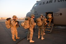 U.S. service members board a C-130H Hercules at an undisclosed location in Southwest Asia Dec. 4, 2016. Over the last three months, the 386th has moved an average of nearly 8,000 passengers a month throughout the U.S. Central Command area of responsibility in support of Operation Inherent Resolve. (U.S. Air Force photo/Senior Airman Andrew Park)