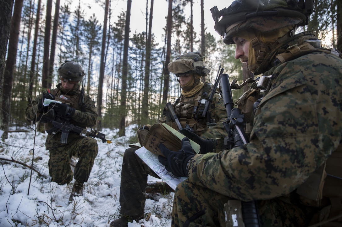 Marines take briefing notes after a final training mission during Exercise Iron Sword 16 at the Rukla Training Area, Lithuania, Dec. 1, 2016. Marine Corps photo by Sgt. Kirstin Merrimarahajara