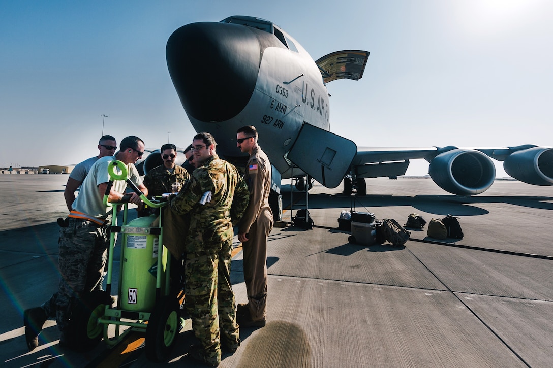 Air Force pilots and crew chiefs discus their mission plan and preflight checks near a KC-135 Stratotanker at Al Udeid Air Base, Qatar, Dec. 1, 2016. The pilots and crew chiefs are assigned to the 340th Expeditionary Air Refueling Squadron. The squadrons extend the fight by delivering 34,600 pounds of fuel to Air Force F-15 Strike Eagles. Air Force photo by Senior Airman Jordan Castelan