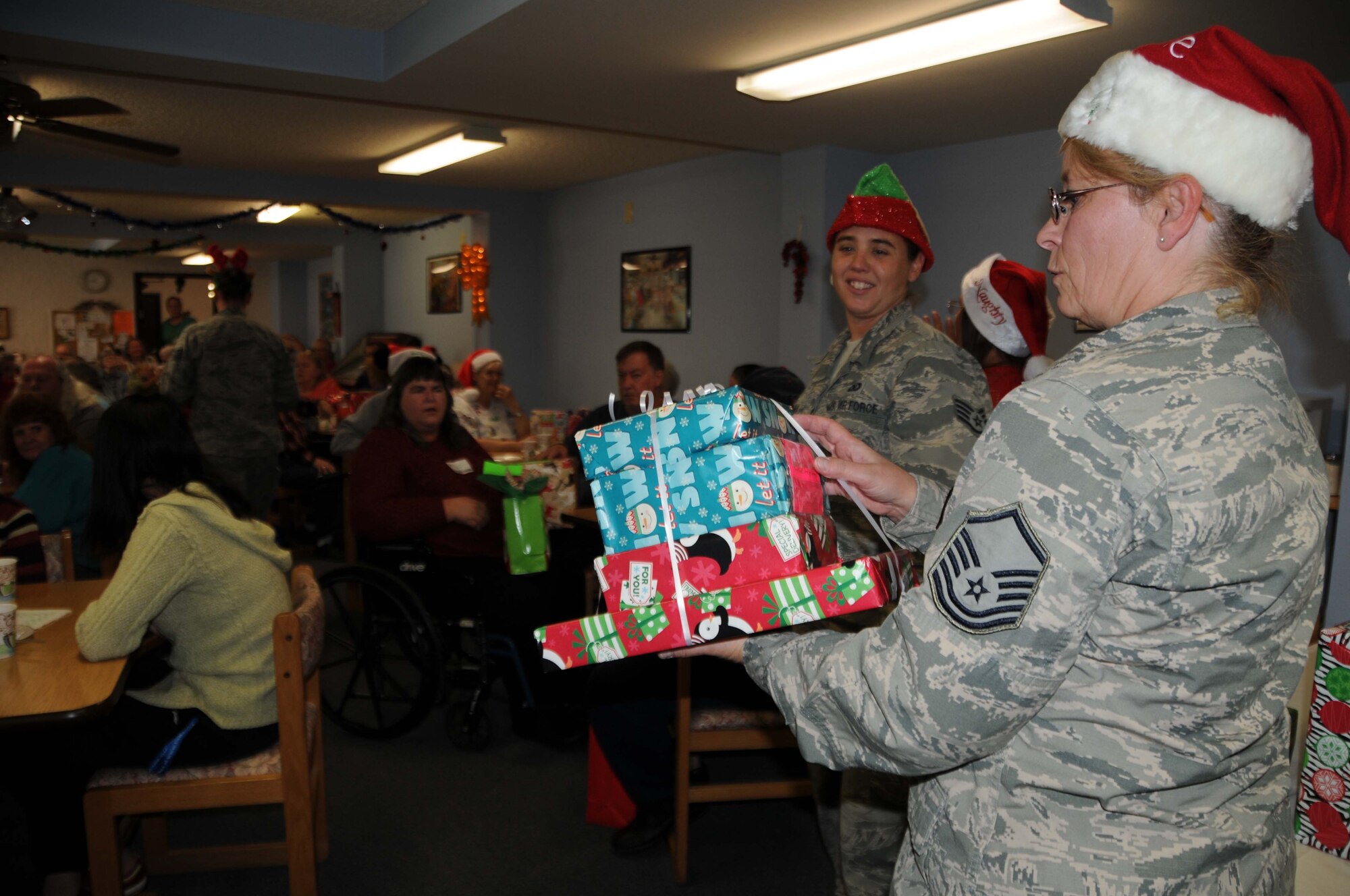 Master Sgt. Kimberly Beecher, 924th Fighter Group training manager, calls out the name and room number of a resident during a holiday party at the Western Winds Apartments, December 3, 2016. Beecher coordinated the event for the 95 tenets because she feels like the elderly are often times forgotten. (U.S. Air Force photo by Tech. Sgt. Courtney Richardson)