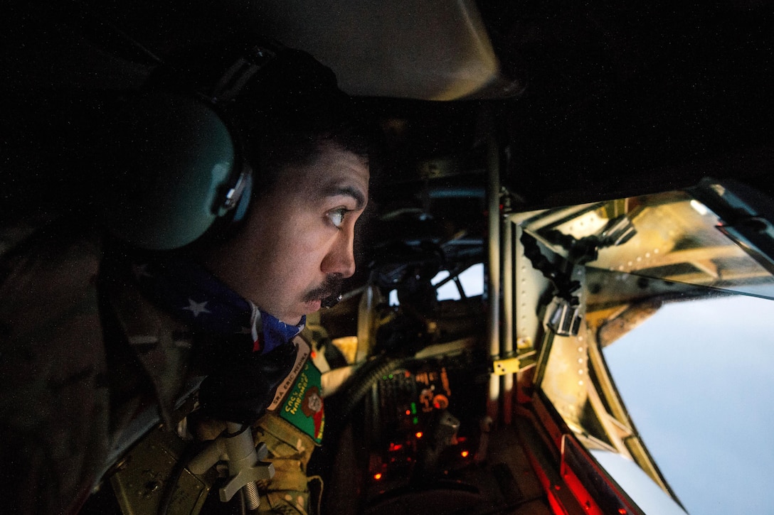 Air Force Senior Airman Eric Medina prepares for an Air Force F-15 Strike Eagle to refuel while in the tail of a KC-135 Stratotanker over Iraq, Dec. 1, 2016. Medina is a boom operator assigned to the 340th Expeditionary Air Refueling Squadron. Air Force photo by Senior Airman Jordan Castelan