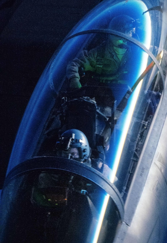 A weapons systems operator in an Air Force F-15 Strike Eagle ensures a safe connection as the aircraft approaches to refuel from a KC-135 Stratotanker over Iraq, Dec. 1, 2016. Air Force photo by Senior Airman Jordan Castelan