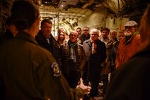 Senior Airman Tristan Geray, 37th Airlift Squadron loadmaster, explains different aspects of her job during a base tour at Ramstein Air Base, Germany , Dec. 2, 2016. A group of local leaders from the Weilerbach Union Community received a tour of Ramstein, and observed the inside of a C-130J Super Hercules. (U.S. Air Force photo by Tech. Sgt. Sara Keller)
