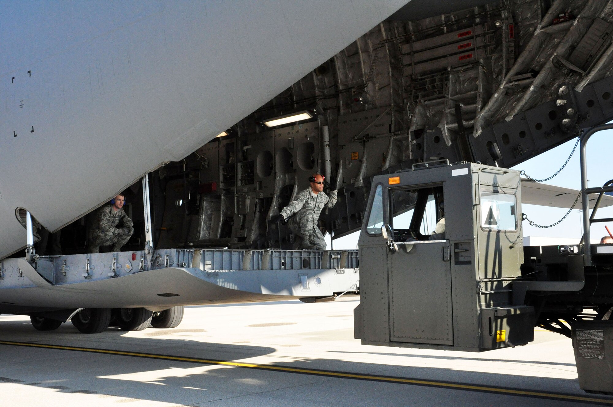Airmen from the 87th Aerial Port Squadron unload cargo from a 445th Airlift Wing C-17 Globemaster III November 6, 2016 on the west ramp at Wright-Patterson Air Force Base, Ohio. (U.S. Air Force photo/Staff Sgt. Rachel Ingram)