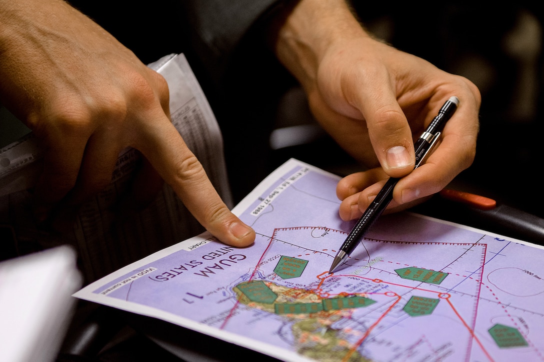 Air Force Capt. Darryl Lawlor reviews his chart during a mission brief for Operation Christmas Drop at Andersen Air Force Base, Guam, Dec. 5, 2016. Lawlor is a navigator assigned to the 36th Airlift Squadron. Air Force photo by Senior Airman Delano Scott